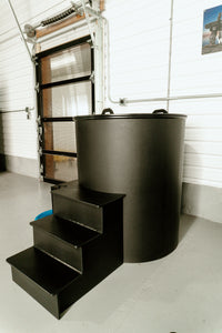 Black three-step entry platform beside the round ice bath tub